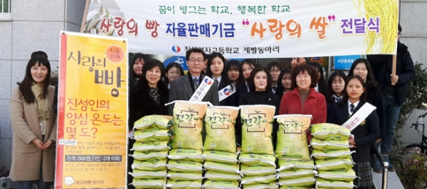 지난 11일 여수 진성여고 학생들이 서강동 주민센터에 사랑의 쌀을 전달하고 있다.