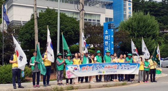 지난 14일 여수시 소라면 새마을지도자 등이 면사무소 앞에서 태극기 달기 캠페인을 벌이고 있다.