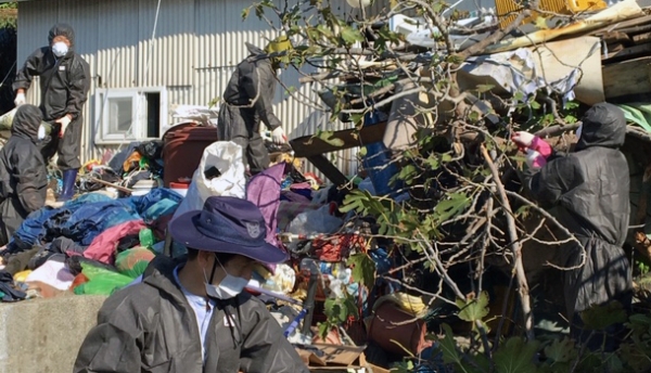 지난 13일 여수시 공무원과 자원봉사자들이 월호동 이모 어르신의 집에 쌓인 쓰레기를 수거하고 있다.